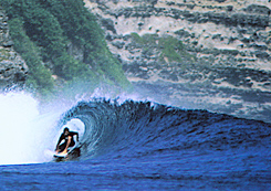 A surfer in a perfect barrel in Bali, Indonesia.